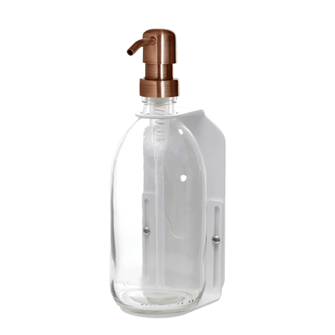White wall mounted soap dispenser clear bottle and copper pump