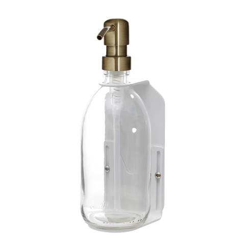White wall mounted soap dispenser clear bottle and gold pump