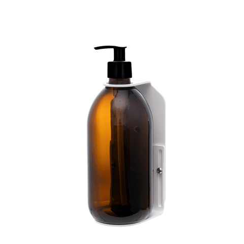 White wall mounted soap dispenser amber bottle and plastic pump