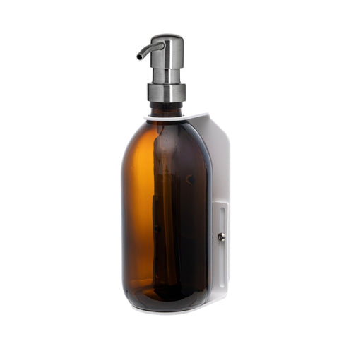 White wall mounted soap dispenser amber bottle and silver pump