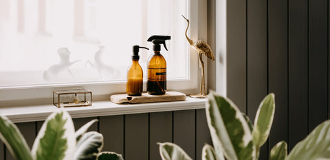 two amber bottles on a bathroom shelve