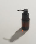 Kuishi Foaming dispenser sat on s shiny surface with colour reflecting 
