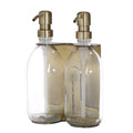 gold double wall mounted holder with clear bottle and gold pumps