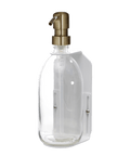 White wall mounted soap dispenser clear bottle and gold pump