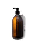 White wall mounted soap dispenser amber bottle and plastic pump