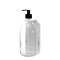 White wall mounted soap dispenser clear bottle and plastic pump